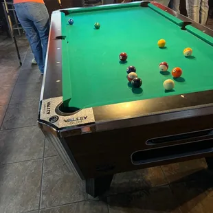 a pool table with billiards on it
