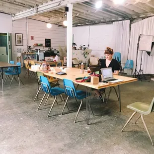 Our main studio houses our community desk space available for rental, our kitchenette, library, and photo studio.