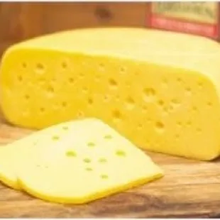 a block of cheese on a cutting board