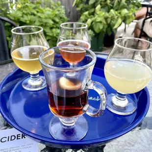 three glasses of cid on a blue tray