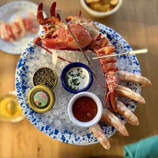 Seafood tower - lobster, stone crab claws, oysters, shrimp cocktail, caviar snack