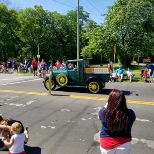 an antique car driving down the street