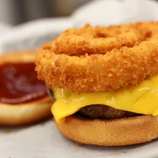 a burger with onion rings and ketchup