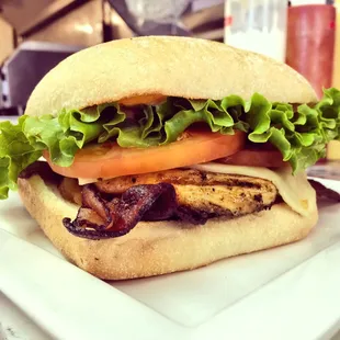 Beef isn't all we do! This is a grilled chicken burger on cabana with bacon and swiss cheese.