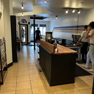 two people standing in a coffee shop