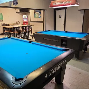 two pool tables and a bar