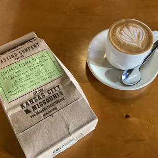 a cup of cappuccino and a box of coffee