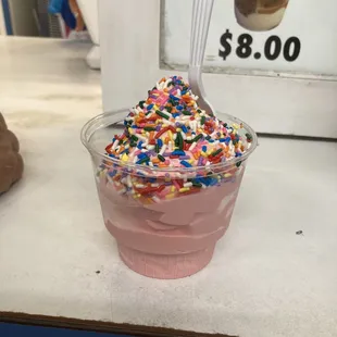 a cup of ice cream with sprinkles