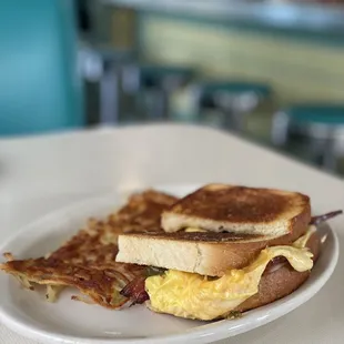 a breakfast sandwich and hash browns