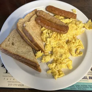 Two scrambled eggs, 3 sausage links, and 2 dry wheat toast.