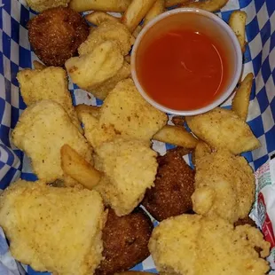 Fried catfish, clearly homemade hushpuppies, and fries.