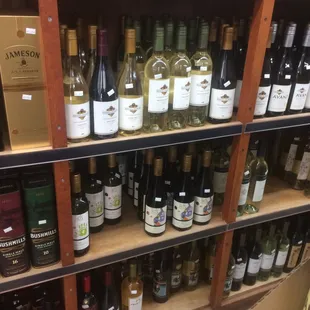 a shelf full of wine bottles