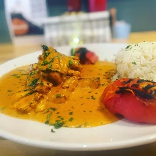 Chicken Curry Served with Rice and Grilled tomatoes