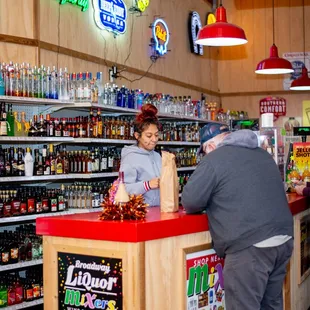 customers at the counter of a liquor store