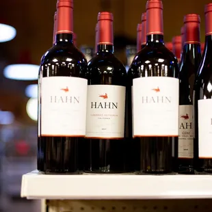 bottles of red wine on a shelf