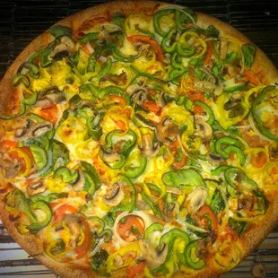 Our succulent veggie lovers pizza, topped with fresh mushrooms, onions, peppers, spinach and tomatoes