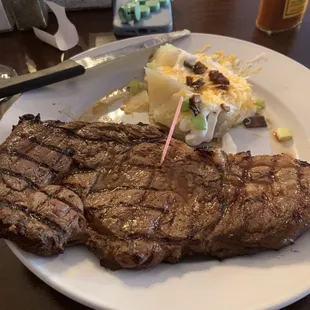 12 oz Ribeye, not the best cut but acceptable with half cooked baked potato. Check out how the "chef" presented the potato