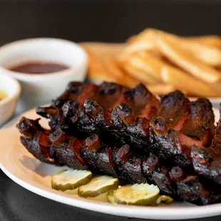 a plate of ribs and french fries