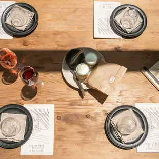 a wooden table with place settings
