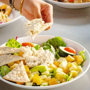 a hand holding a piece of bread