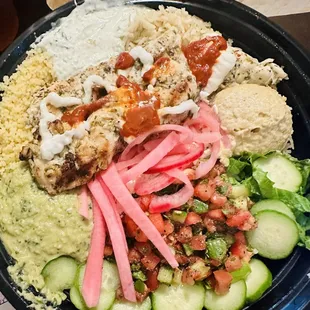 Garlic chicken bowl with many sides.  Including jalapeño hummus