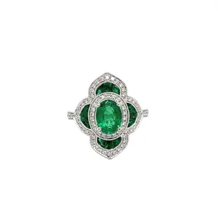 18kt white gold ring with a 1.08 ct oval emerald, and is accented with 12 custom-cut emeralds weighing 0.89 cts, and 76 round diamond accent