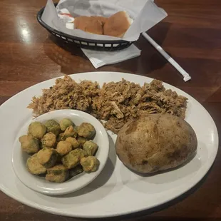 Pulled pork platter with fried okra and baked potato.