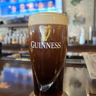 a pint of guinness on a bar