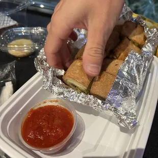 Chicken stromboli (hot). Pizza dough stuffed with herb roasted chicken, spinach, mushroom, tomato, garlic, and mozzarella.