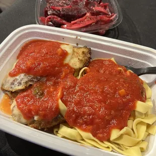 Chicken parmigiana. Grana padano-crusted chicken breast topped with provolone and served with egg fettucine and pomodoro sauce.