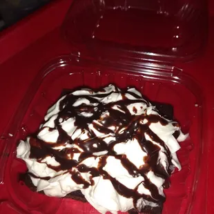 Hot Brownie smothered in whip cream and chocolate syrup