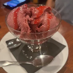 a bowl of ice cream with strawberries