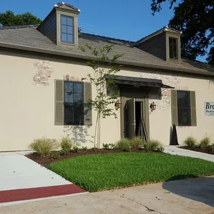 the front of a house with a car parked in front of it