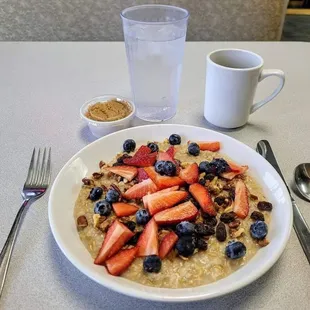 Loaded Oatmeal Special with strawberries, blueberries, pecans, walnuts, and raisins minus the banana and milk for me.