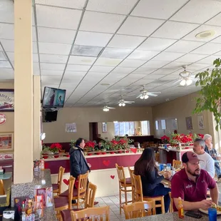 people sitting at tables in a restaurant
