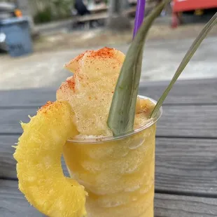 Pineapple peach smoothie in a cup
