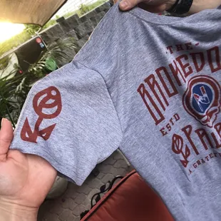 a person holding a t - shirt