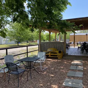 a patio with tables and chairs