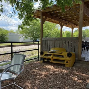 a yellow truck in a fenced in area