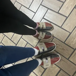 two people standing on a tiled floor