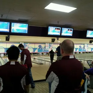 a group of people watching a bowling game