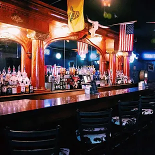 a bar with american flags hanging from the ceiling