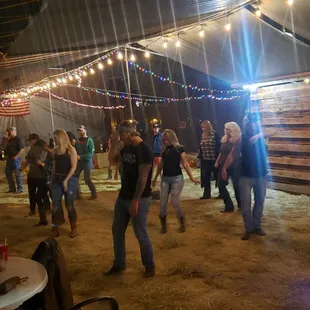 people dancing in a barn
