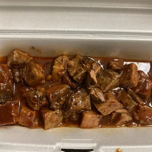 A pile of meat that isn't burnt ends. Looks like canned meat.