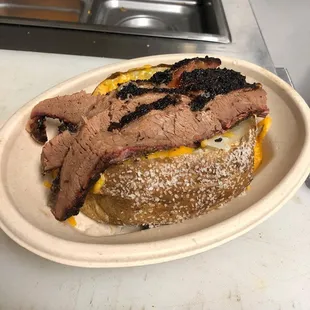 Loaded baked potato: cheddar cheese, sour cream, topped with brisket