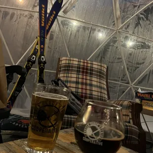 a glass of beer and a pair of skis