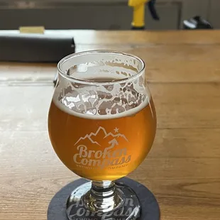 a glass of beer on a coaster
