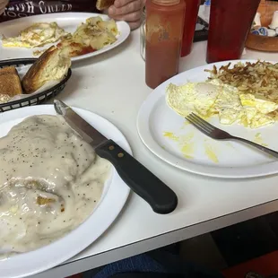 Country fried steak which came with two eggs a huge delicious biscuit and potatoes.