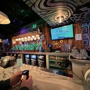 a man taking a picture of the bar