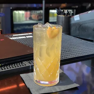 a glass of lemonade on a bar